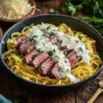 Serve the pasta topped with the cooked steak strips Recipe