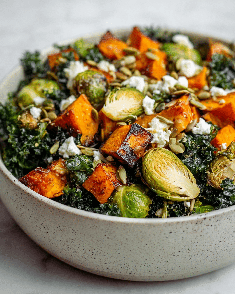 A bowl filled with a fresh salad starting with a base layer of dark green curly kale. On top, there are bright orange roasted pumpkin chunks with crispy, slightly charred edges, and several halved Brussels sprouts that have a roasted, browned outside with green leaves inside. Scattered over the salad are small white crumbles of cheese and light brown sunflower seeds. The bowl is white with a speckled texture, and the whole scene rests on a white marbled surface. photo taken with an iphone --ar 4:5 --v 7