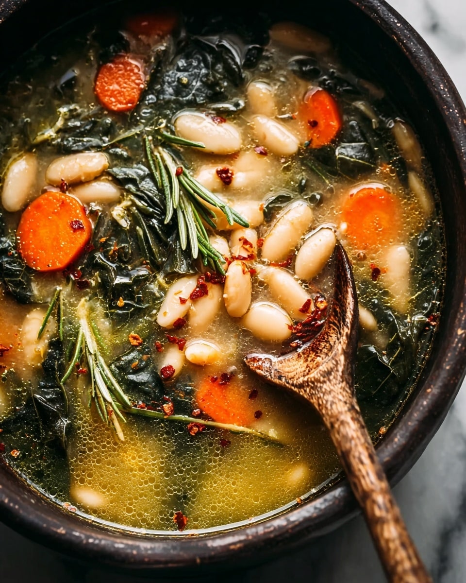 A close-up view of a bowl filled with soup showing two main layers: the base layer is a light yellow broth with a bit of oil and bubbles on the surface, and the top layer consists of white beans, bright orange carrot slices, dark green leafy vegetables, and green rosemary sprigs scattered across. There are also small red pepper flakes sprinkled on top for texture and color. A wooden spoon with a rough texture is partially submerged in the soup on the right side, holding some beans, carrot slice, and a rosemary sprig. The bowl is dark and rustic, placed against a white marbled texture background. Photo taken with an iphone --ar 4:5 --v 7