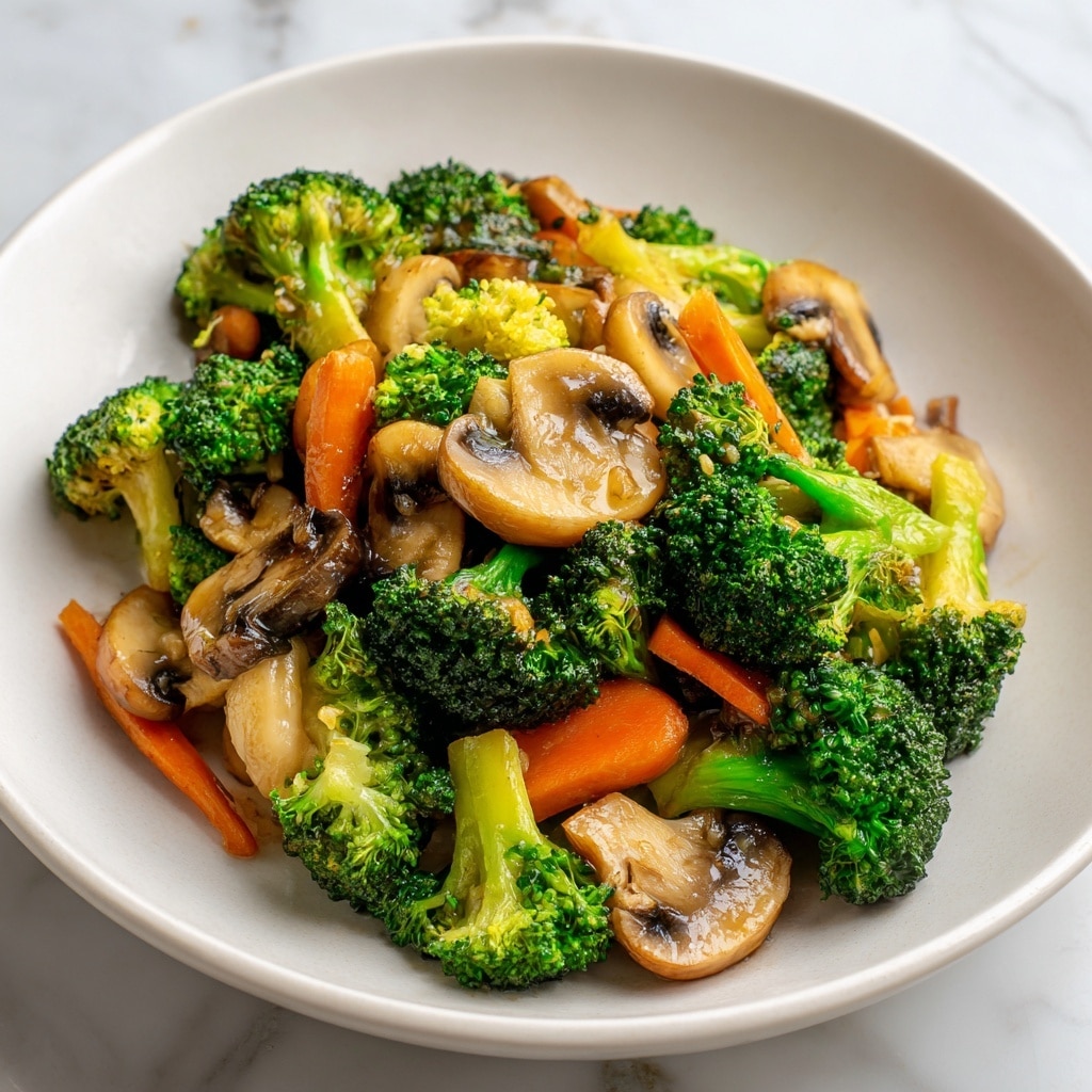 The image shows a white plate with a colorful vegetable stir-fry. The dish has bright green broccoli florets with a slightly rough texture, orange carrot slices cut thick and slightly soft, and light brown mushroom slices with a smooth, glossy look scattered evenly throughout. The vegetables sit close together, some overlapping, and all appear cooked but still fresh and crisp. The plate rests on a white marbled surface. Photo taken with an iphone --ar 4:5 --v 7