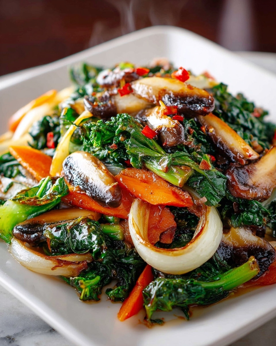 A white square plate holds a colorful stir-fry with three main layers: the base is bright orange carrot sticks, layered with large, glossy green leafy vegetables, and topped with browned, sliced mushrooms and golden caramelized onion pieces. The greens are mixed with small bits of red chili flakes, adding a pop of red contrast. The food looks shiny with oil and is fresh and hot, with steam gently rising. The plate sits on a dark textured mat over a white marbled surface. photo taken with an iphone --ar 4:5 --v 7
