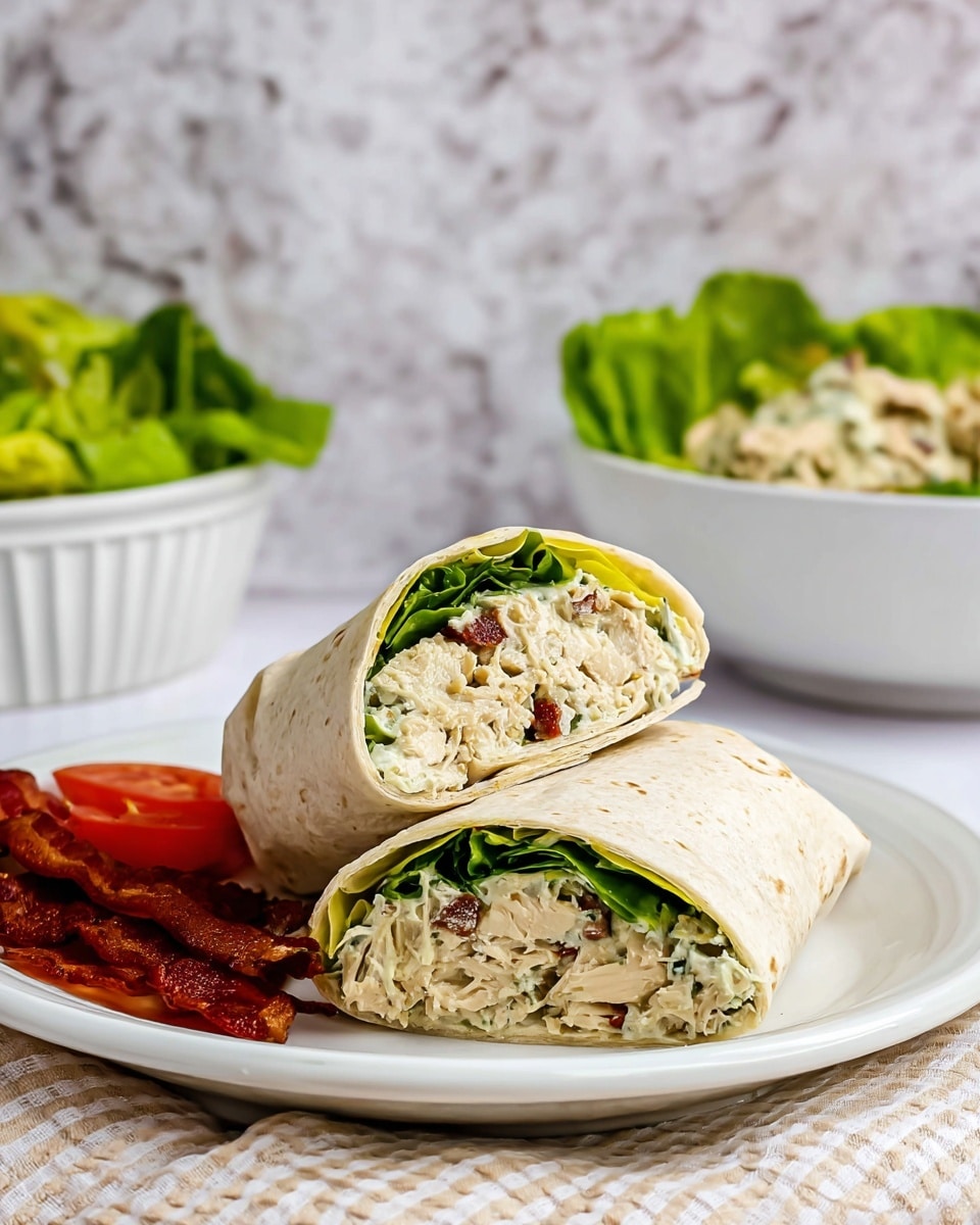 The image shows a close-up of a glass bowl filled with a creamy chicken salad mix. The salad has shredded white chicken pieces mixed with small green celery slices, dark brown pecan nuts, and a white creamy dressing that coats all ingredients thickly. A white spatula is partially stuck in the salad on the right side, with the creamy mixture clinging to it. The bowl is placed on a surface with a white marbled texture. photo taken with an iphone --ar 4:5 --v 7