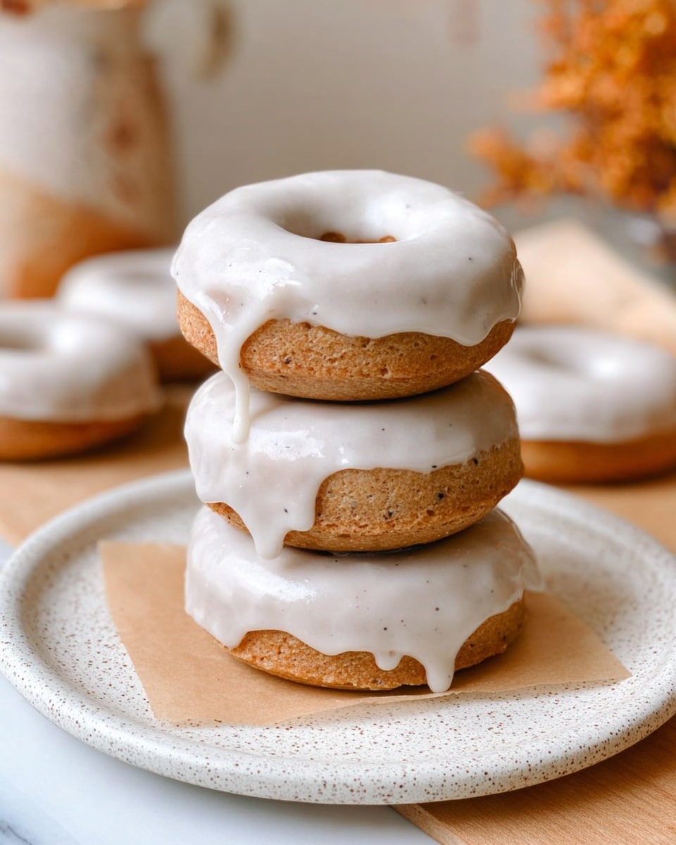 Seven small donuts are placed on crumpled brown parchment paper, each topped with a thick, smooth layer of white icing that covers the top entirely and slightly drips down the sides. The donuts are light brown with a soft texture visible beneath the icing. The background shows a white marbled surface, a white vase with a large round hole in the middle, and a woven basket with natural brown and black patterns. The lighting is soft and natural, highlighting the glossy finish of the icing and the donut's texture. photo taken with an iphone --ar 4:5 --v 7