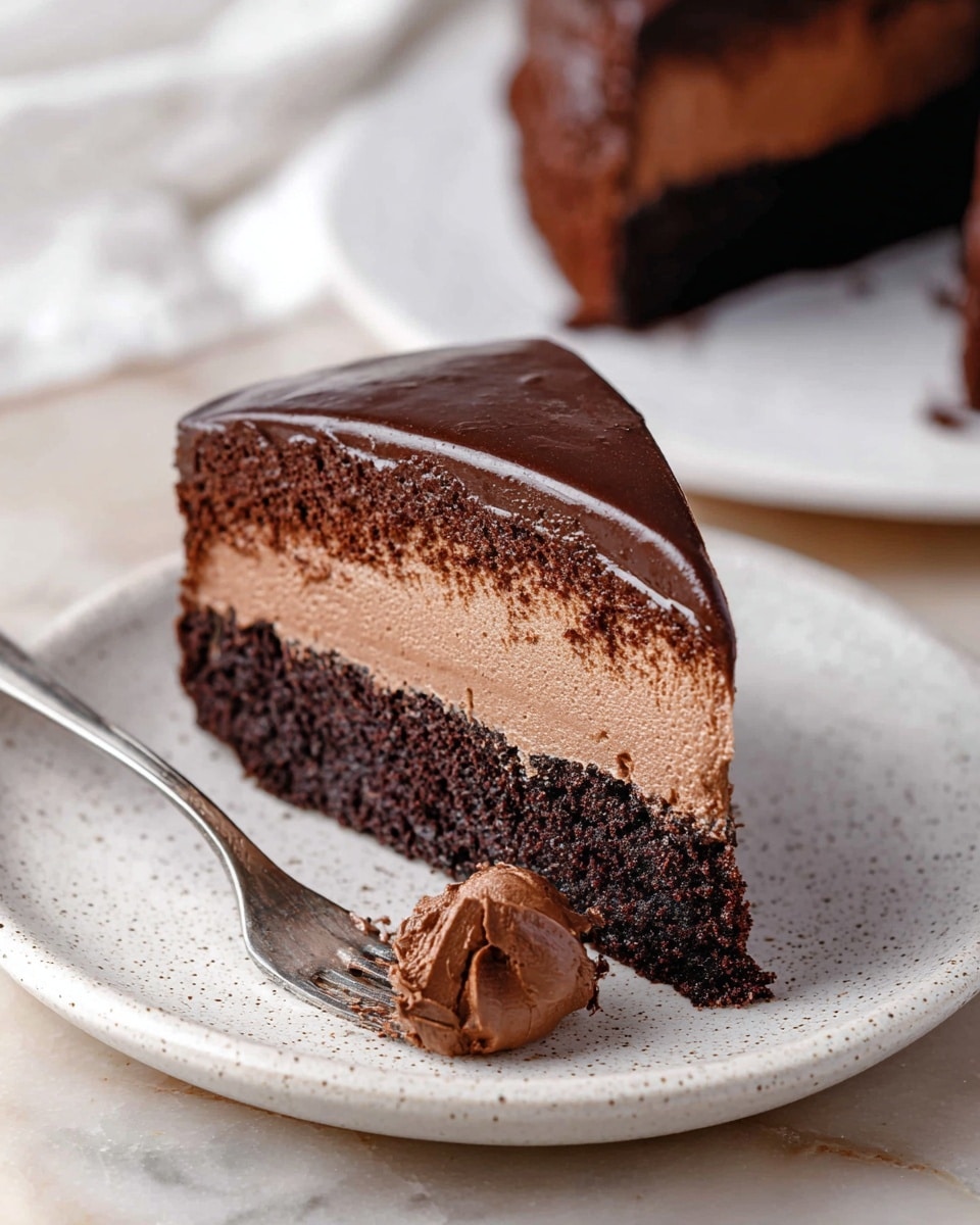 A close-up of a sliced chocolate cake with three visible layers: a dark, moist chocolate base at the bottom with a rough texture, a smooth and creamy light chocolate mousse layer in the middle, and a shiny, dark chocolate ganache layer on top with a glossy finish. The slice in front shows the thickness of each layer clearly, resting on a white marbled board with a wooden side visible. The cake is cut into even triangular pieces with clean edges, showing a rich and smooth finish on the ganache. Photo taken with an iphone --ar 4:5 --v 7