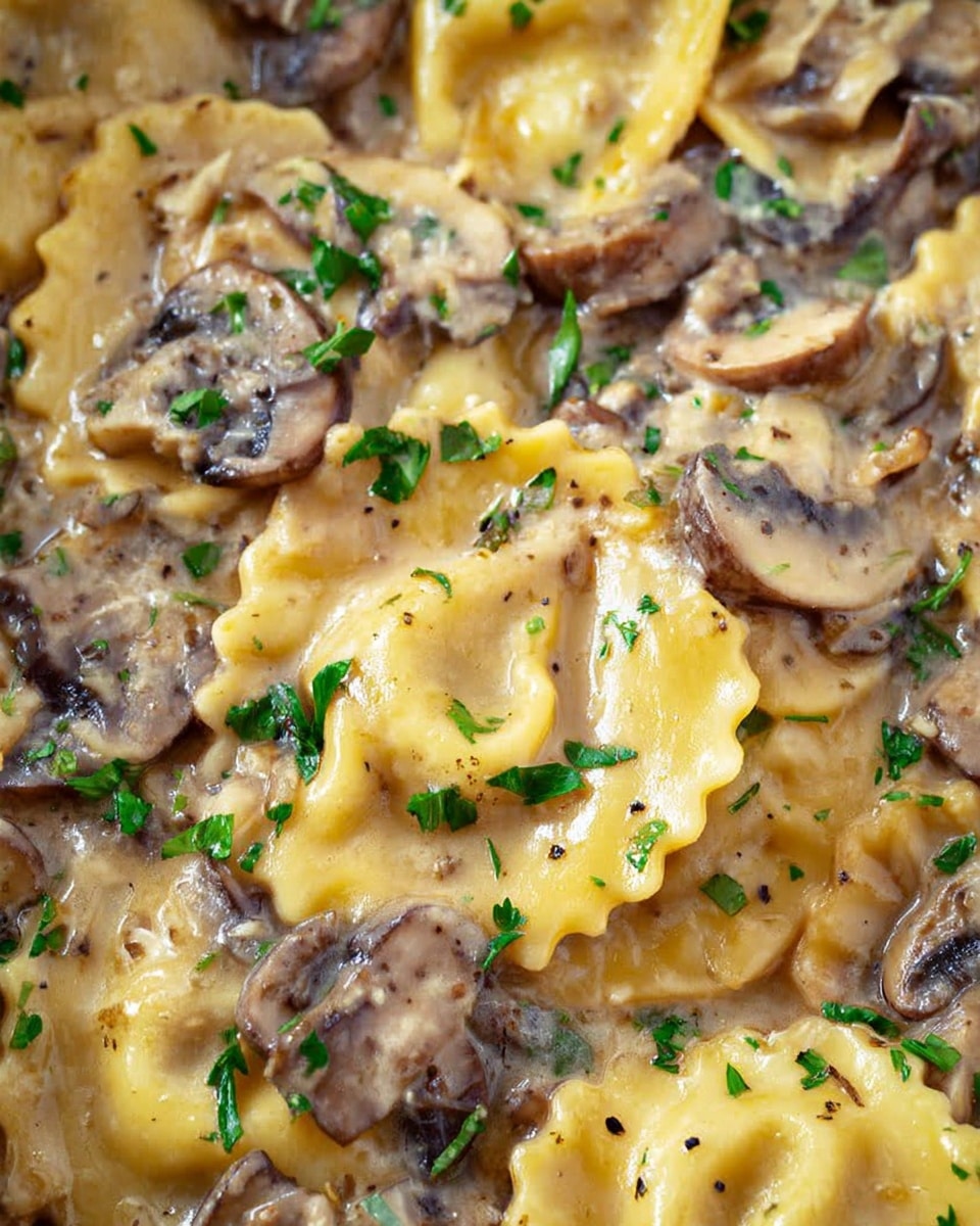 This image shows a close-up of a pan filled with creamy mushroom ravioli. The ravioli have a yellow color with slightly scalloped edges, each piece coated in a thick, beige cream sauce speckled with black pepper. Sliced brown mushrooms are scattered evenly throughout, mixed into the sauce. Fresh green parsley leaves are sprinkled on top, adding a bright contrast. A wooden spoon is lifting some ravioli and mushrooms from the pan, held by a woman's hand. The background is a white marbled texture. photo taken with an iphone --ar 4:5 --v 7