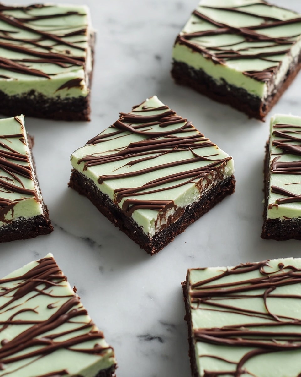 The image shows multiple square pieces of a dessert laid out on a white marbled surface. Each piece has three clear layers: the bottom layer is a dark brown, moist cake or brownie; the middle layer is light and creamy, possibly a white or beige filling; the top layer is a smooth, pale green frosting spread evenly with a slightly glossy finish. On top of this green frosting, there are random, thin lines of dark brown chocolate drizzle creating a casual, artistic pattern. The edges of the pieces are clean and sharp, showing the contrast between each layer clearly. photo taken with an iphone --ar 4:5 --v 7