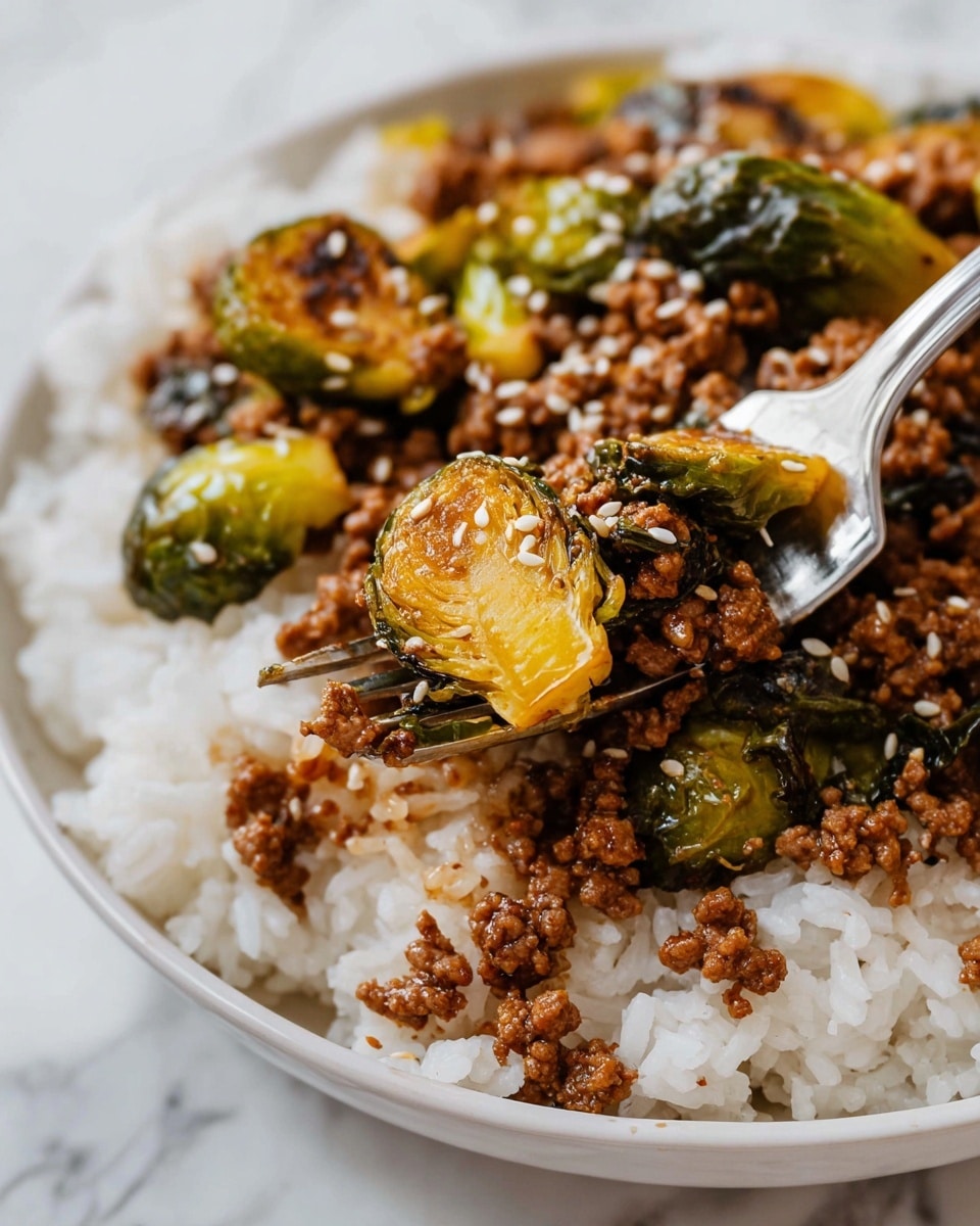 The image shows a close-up of a dish with three layers. The bottom layer is white rice, fluffy and slightly separated. On top of the rice is a layer of cooked Brussels sprouts, cut in halves and quarters, with a roasted yellowish-green color and slight charring. Mixed with the sprouts is a layer of browned ground meat, crumbly and moist with a rich brown color. Small white sesame seeds are sprinkled over the dish, adding texture and contrast. A silver fork holds a bite, showing both Brussels sprouts and ground meat together. The dish sits on a white plate against a white marbled background. Photo taken with an iphone --ar 4:5 --v 7