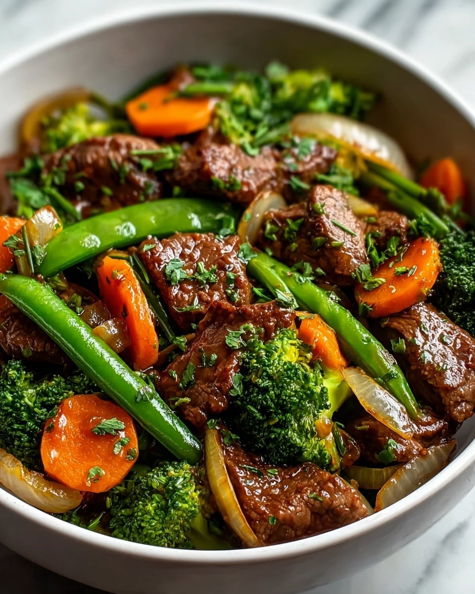 A close-up of a stir-fry dish showing multiple thick, glossy brown beef pieces sprinkled with small green chopped herbs and sesame seeds scattered on top. The beef pieces lie mixed among bright vegetables: vibrant green broccoli florets, crisp snap peas, long strips of red and yellow bell peppers, and translucent cooked onion slices with a shiny texture. The layers are tightly mixed, each ingredient clearly visible with fresh, juicy textures. The dish is set against a white marbled background. photo taken with an iphone --ar 4:5 --v 7